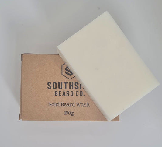 unscented solid beard shampoo from southside beard co on a white background. Beard shampoo resting on packaging with the logo showing from a birds eye view.