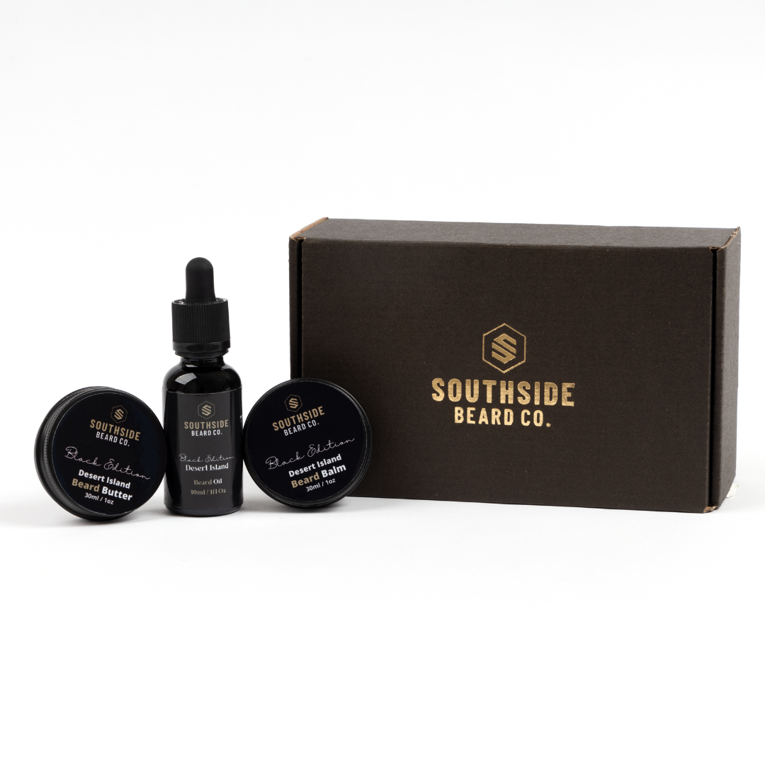 A front image of a beard care gift set containing beard oil, beard balm and beard butter with it's packaging beside it on a white background.