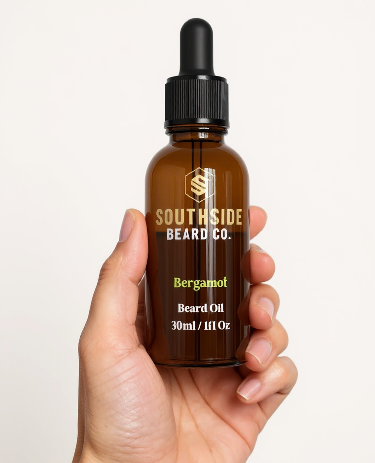 Hand holding a Southside Beard Co bergamot beard oil bottle against a white background