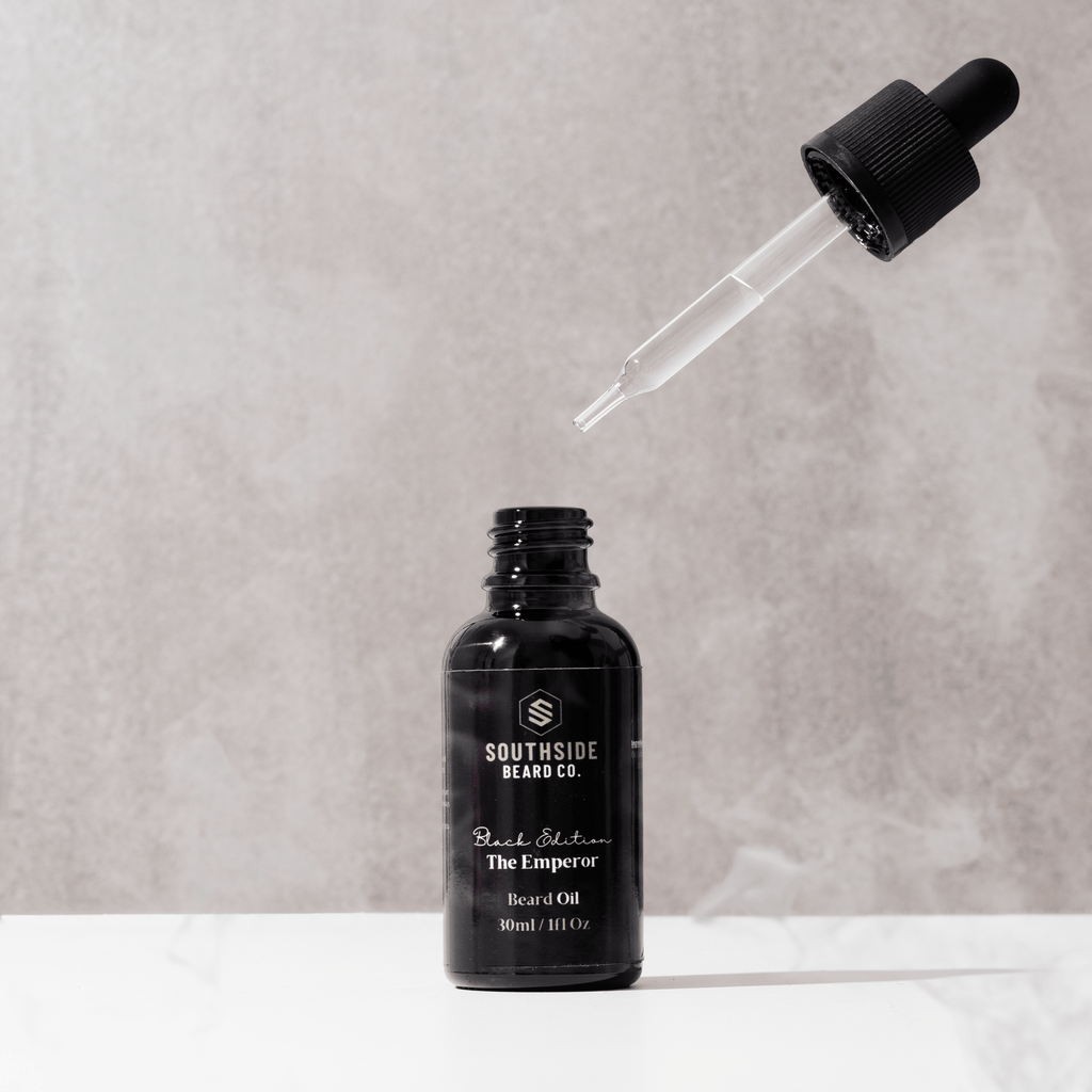 Black edition beard oil from Southside beard co with 30ml glass dropper and pipette floating in the background