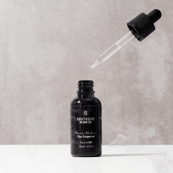 Black edition beard oil from Southside beard co with 30ml glass dropper and pipette floating in the background