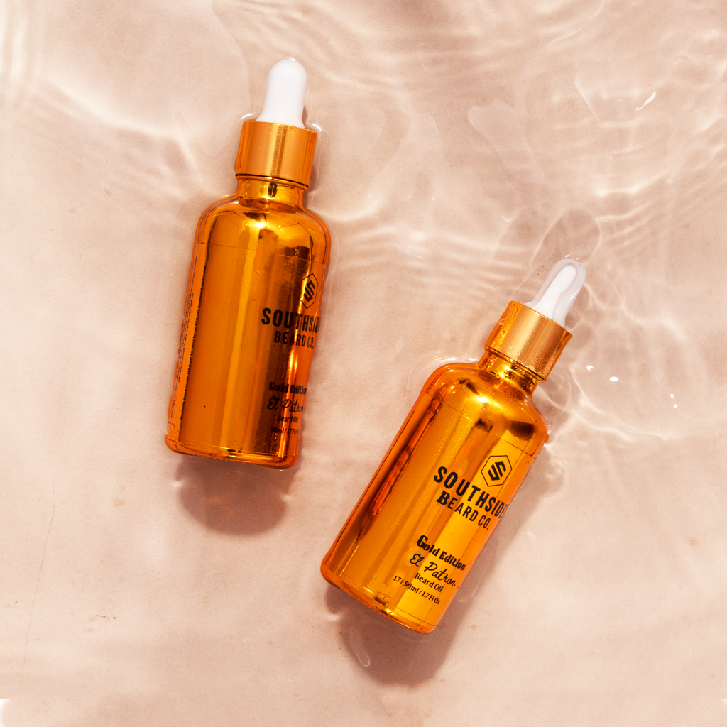 Birds eye view of two gold dropper bottles from southside beard co gold edition on a nude colour background