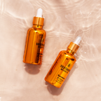 Birds eye view of two gold dropper bottles from southside beard co gold edition on a nude colour background